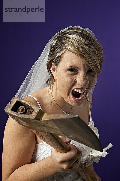 Angry young bride with an axe on a dark blue background