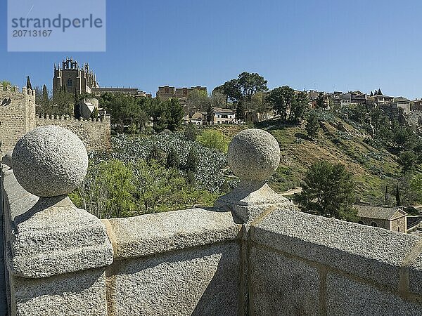 View of the fortress and church from a bridge with stone spheres in a hilly landscape  Toledo  Spain  Europe