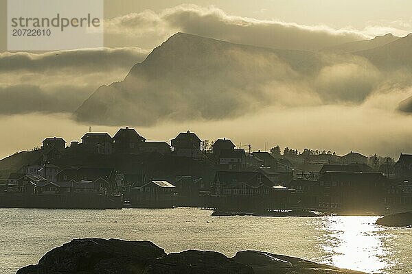 Village with houses in the fog  backlight  sea fog  A i Lofoten  Lofoten  Norway  Europe