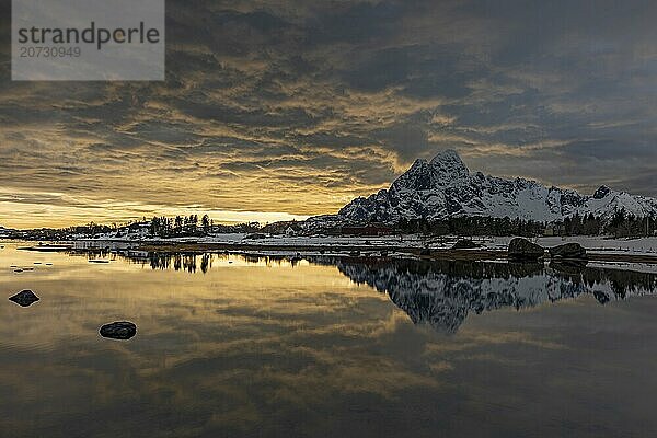 Dramatic evening mood over steep mountains  coast  reflection  Vagakallen  Austvagoya  Lofoten  Norway  Europe