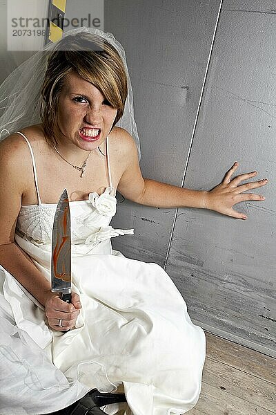 Angry young bride with a bloody knife in an elevator