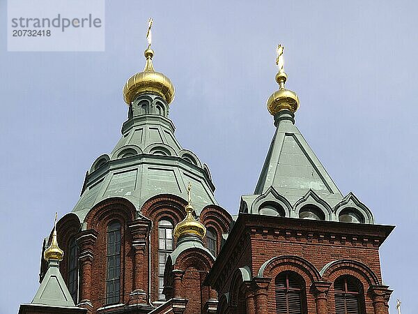 From Wikipedia: Uspenski Cathedral is an Orthodox church in the Finnish capital Helsinki. It is the cathedral of the Finnish Orthodox Diocese of Helsinki. The name of the cathedral comes from the Russian and means Cathedral of the Assumption. The Uspenski Cathedral is located on a rock at the western end of the Katajanokka peninsula in the centre of Helsinki. At the time of its construction  the church  visible from afar  was a clear symbol of Russian rule over Finland. Today it is one of the most important sights in the Finnish capital and attracts around 500  000 visitors a year. The Uspenski Cathedral was designed by architect Alexei Gornostayev in the Russian-Byzantine style and consecrated in 1868. The red-brick cathedral is the largest Orthodox church in western Europe. It has 13 domes with gilded spires. The opulently decorated interior is supported by four massive granite columns  which form the main cupola