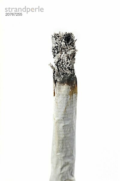 Hand rolled burning cigarette isolated on white