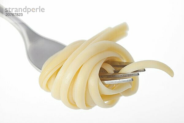 Spaghetti on a fork on white background