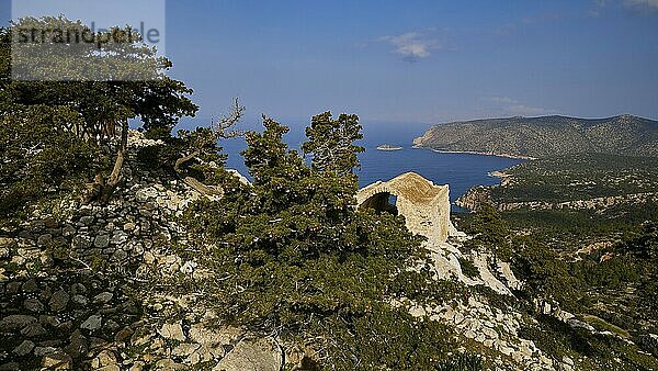 Fascinating view of the coast with mountains  sea and ruins  surrounded by trees and sky  Kastro Monolithou  Monolithos Castle  rock castle  Monolithos village  Rhodes  Dodecanese  Greek Islands  Greece  Europe