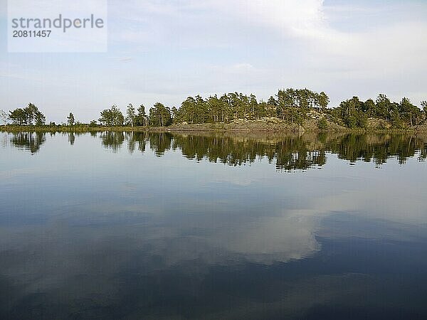 Reflection in the water of Slöingen bay  mirroring in sweden on lake vänern