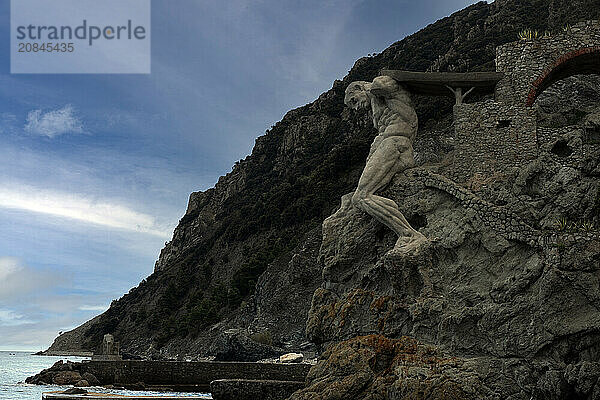 Il Gigante  a stone sculpture representing Neptune  Roman god of the sea  at the end of Fegina Beach  Monterosso al Mare  Cinque Terre  UNESCO World Heritage Site  Liguria  Italy  Europe.