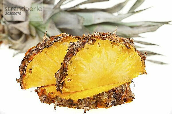 Slices of a ripe pineapple against a white background