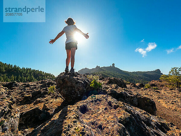 A woman hiker at a viewpoint of Roque Nublo in Gran Canaria  Canary Islands