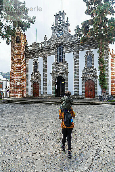 A mother with her son visiting the Basilica of Nuestra Senora del Pino in the municipality of Teror. Gran Canaria  Spain  Europe