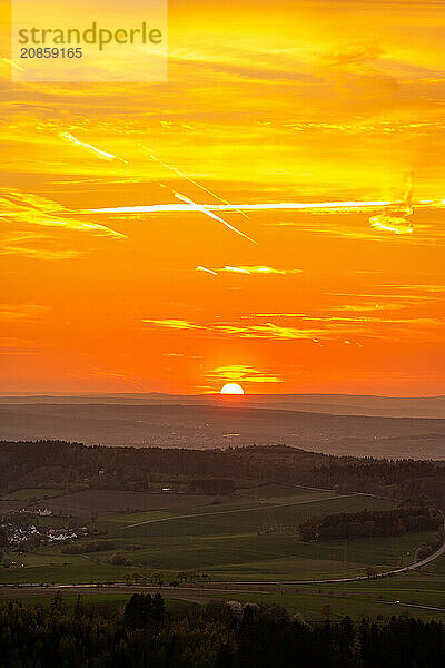 Panorama of a romantic landscape at sunset in the evening light. beautiful spring landscape in the mountains. Lawn and rolling hills. View from a cliff to the horizon. The Great Peak  Hesse  Germany  Europe