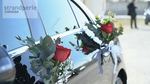 Wedding car decorated with flowers and ribbons  closeup