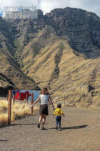 A mother and her son walking and having fun in the mountains of the Agaete coast  Roque Guayedra  Gran Canaria