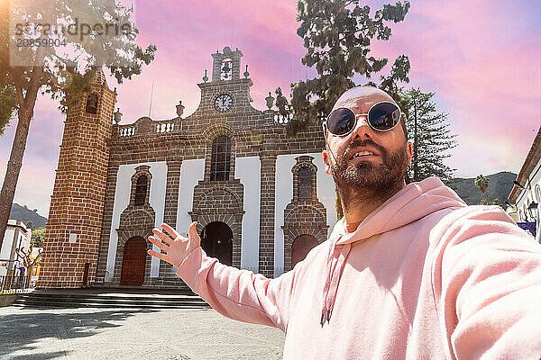 Selfie of a tourist at sunset next to the Basilica of Nuestra Senora del Pino in the municipality of Teror. Gran Canaria  Spain  Europe