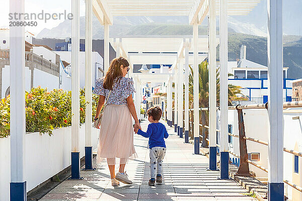 A mother with her son on vacation at Puerto de Las Nieves in Agaete on Gran Canaria  Spain  Europe