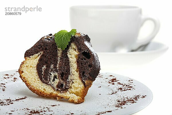 Marble cake with icing sugar on a plate on a white background