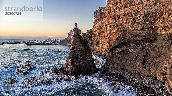 Aerial view of the cliffs and coast of Agaete at summer sunset in Gran Canaria. Spain