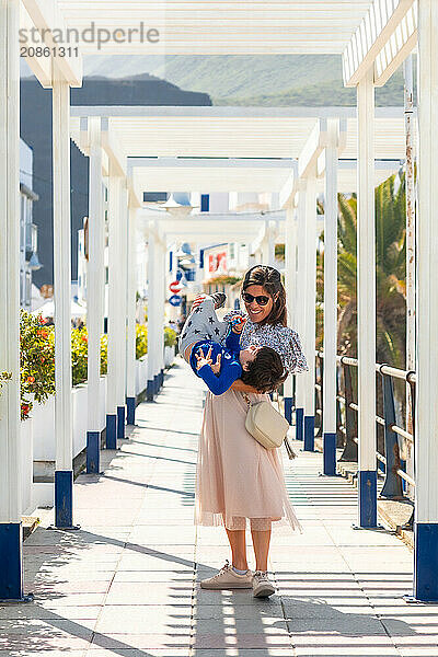 A mother with her son playing on holiday in Puerto de Las Nieves in Agaete on Gran Canaria  Spain  Europe