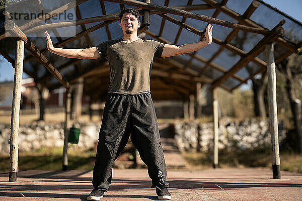 A man practices Yi Jin Jing  a Buddhist Chinese training method known as Changing Muscles and Tendons in Chi Kung  stimulating vital energy (qi) flow