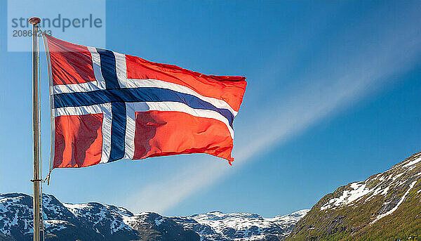 The flag of Norway flutters in the wind  isolated against a blue sky