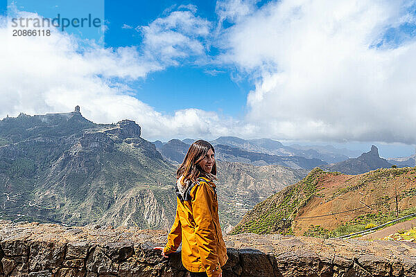 Portrait of a woman looking at Roque Nublo from a viewpoint on the mountain. Gran Canaria  Spain  Europe