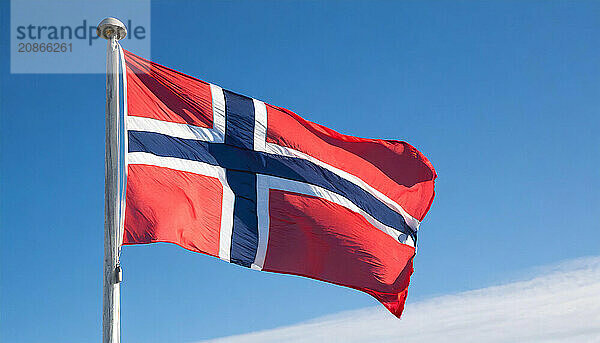 The flag of Norway flutters in the wind  isolated against a blue sky