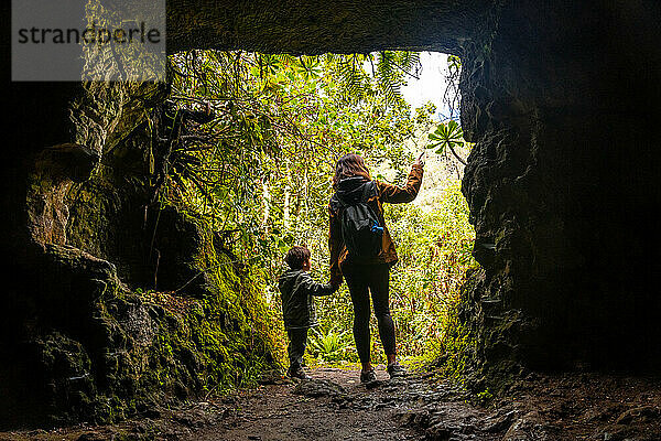 A child and his mother in a cave in the Laurisilva forest of Los tilos de Moya  Gran Canaria