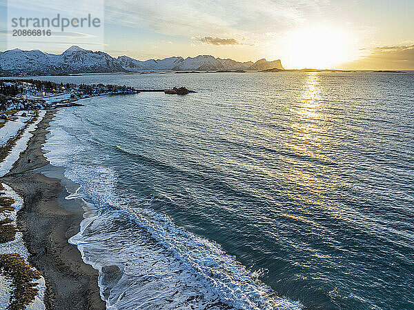 Aerial view of beach and sea at sunset  sea spray  coast  mountains  Senja  Troms  Norway  Europe