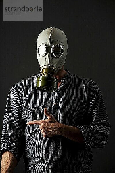 Man in a gas mask on a black background