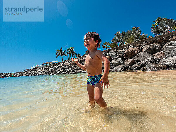 Child on vacation on a beach in the Canary Islands. Concept of happy family outdoors. Family vacation on the sea coast