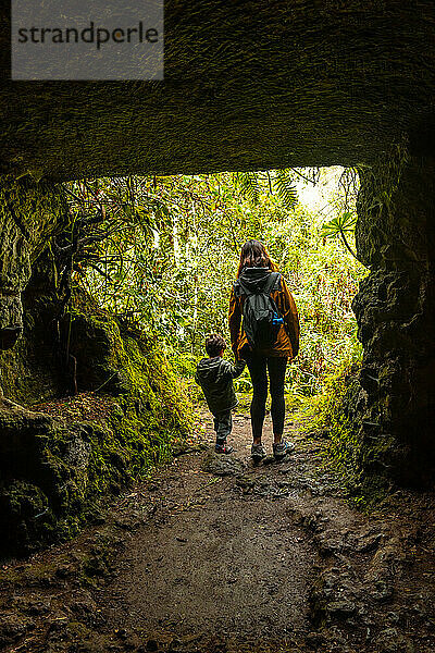 A child and his mother in a cave in the Laurisilva forest of Los tilos de Moya  Gran Canaria