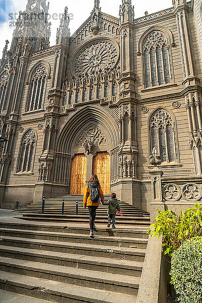 A mother with her son visiting the Church of San Juan Bautista  Arucas Cathedral  Gran Canaria  Spain  Europe