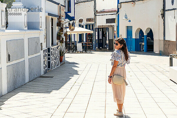 A woman walking through Puerto de Las Nieves in Agaete on Gran Canaria  Spain  Europe