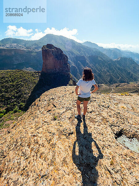 A woman with her back turned at the Roque Palmes viewpoint near Roque Nublo in Gran Canaria  Canary Islands