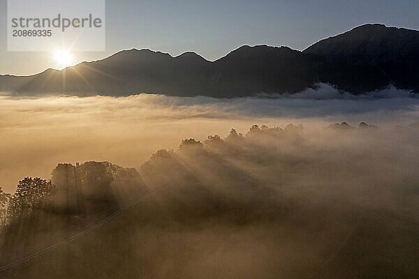 Aerial view  fog in front of mountains  sunrise  backlight  summer  view of Kochler mountains with Jochberg  Alpine foothills  Bavaria  Germany  Europe