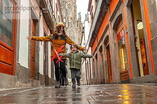 A mother playing with her son on a street near the Church of San Juan Bautista  Arucas Cathedral  Gran Canaria  Spain  Europe