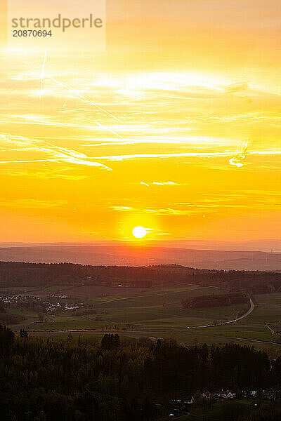 Panorama of a romantic landscape at sunset in the evening light. beautiful spring landscape in the mountains. Lawn and rolling hills. View from a cliff to the horizon. The Great Peak  Hesse  Germany  Europe