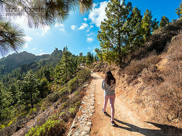 A woman hiker on the trail up to Roque Nublo in Gran Canaria  Canary Islands