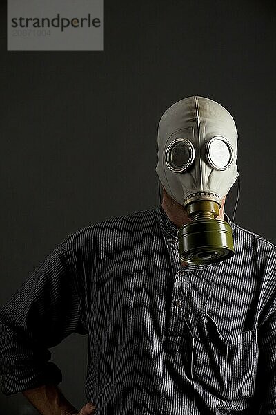 Man in a gas mask on a black background