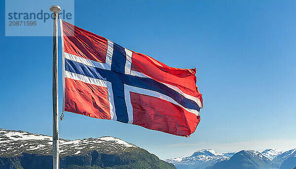 The flag of Norway flutters in the wind  isolated against a blue sky