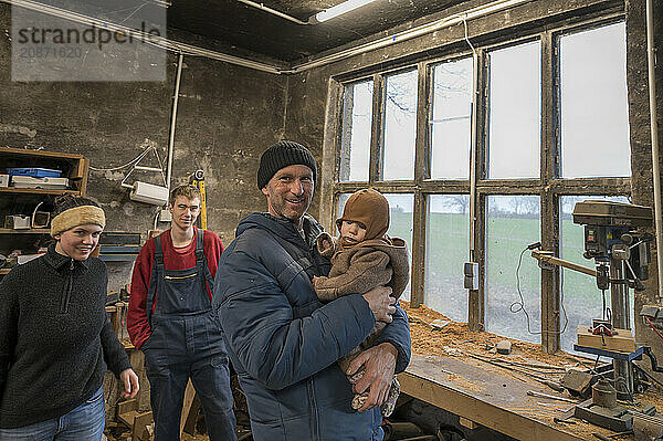 Family reunion in the workshop  father  daughter  son and grandson  Mecklenburg-Vorpommern  Germany  Europe