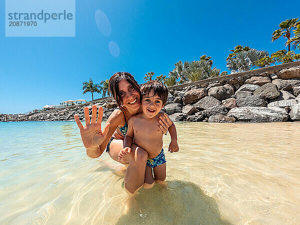 Mother and son on vacation on a beach in the Canary Islands. Concept of happy family outdoors. Family vacation on the sea coast