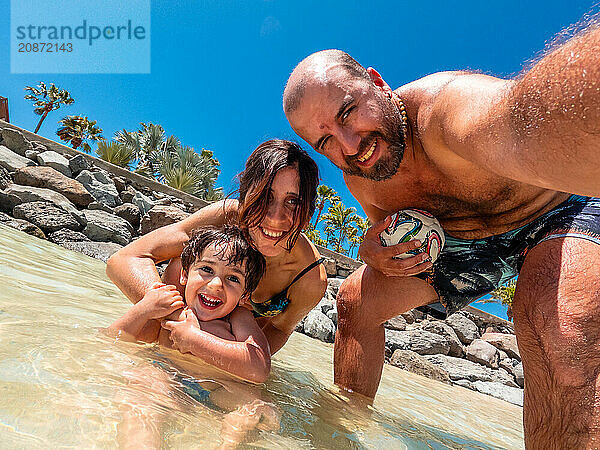 A family on vacation on a beach in the Canary Islands. Concept of happy family outdoors. Family vacation on the sea coast