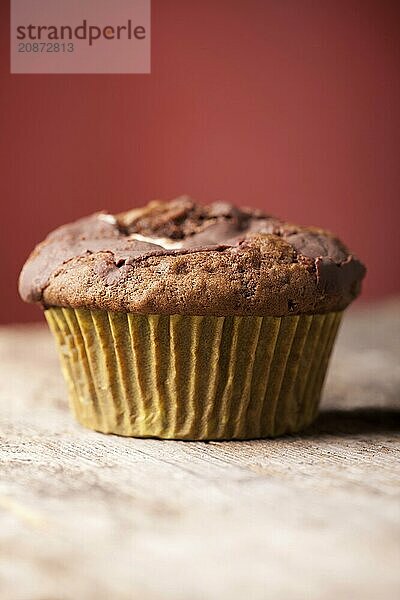 Single muffin on a red background