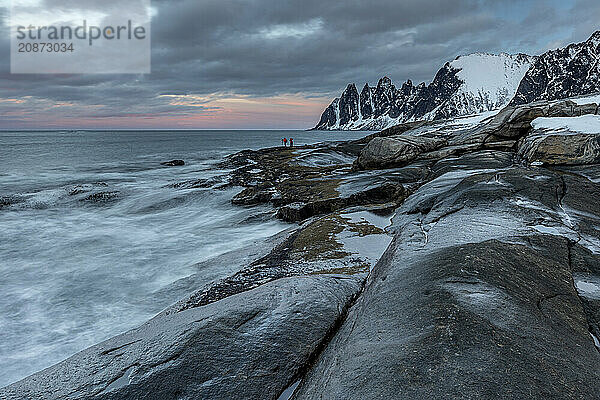 Rocky coast with sea spray  mountains  winter  cloudy  Tungeneset  Senja  Troms  Norway  Europe