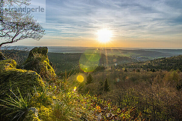 Panorama of a romantic landscape at sunset in the evening light. beautiful spring landscape in the mountains. Lawn and rolling hills. View from a cliff to the horizon. The Great Peak  Hesse  Germany  Europe