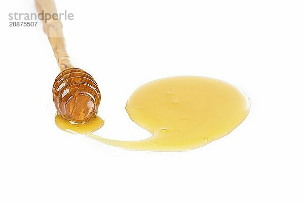 Spoon of honey on a white background. Closeup