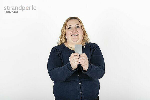 Woman smiling happily showing her credit card