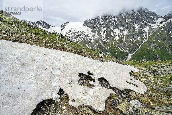 Mountaineer climbing over a snowfield to the Lapenscharte  Berliner Höhenweg  Zillertal Alps  Tyrol  Austria  Europe