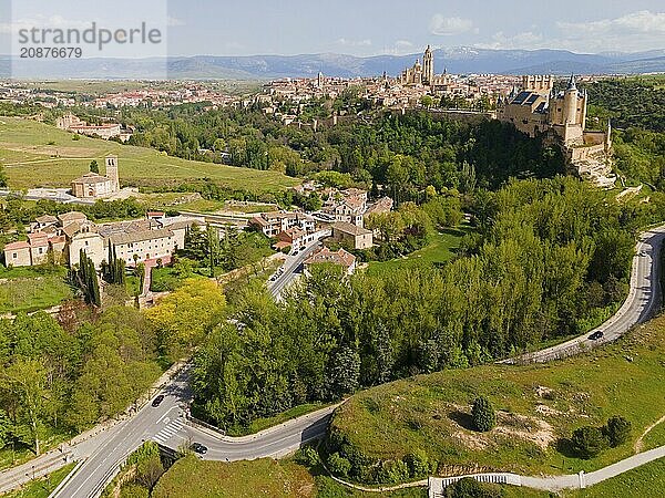 Aerial view of a medieval town with castles and green surroundings in a hilly valley  aerial view with wide view  some buildings with modern plaster  aerial view  aqueduct  Segovia  Castilla y León  Leon  Spain  Europe